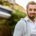 Young happy Indian man smiling outdoors horizontal shot